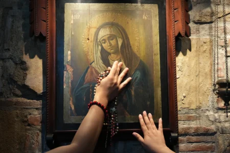 Des catholiques touchent une des images de Marie à l'intérieur de la Maison d'Éphèse, une réplique de la Maison de la Vierge Marie à Éphèse, en Turquie, dans la ville d'Alfonso, province de Cavite, Philippines, le 16 juillet 2026. (Crédit : Aaron Favila/AP.)